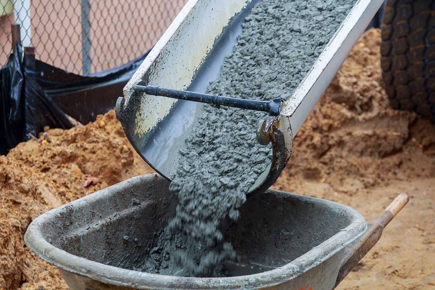 wheelbarrow-pouring-mortar-into-the-foundations